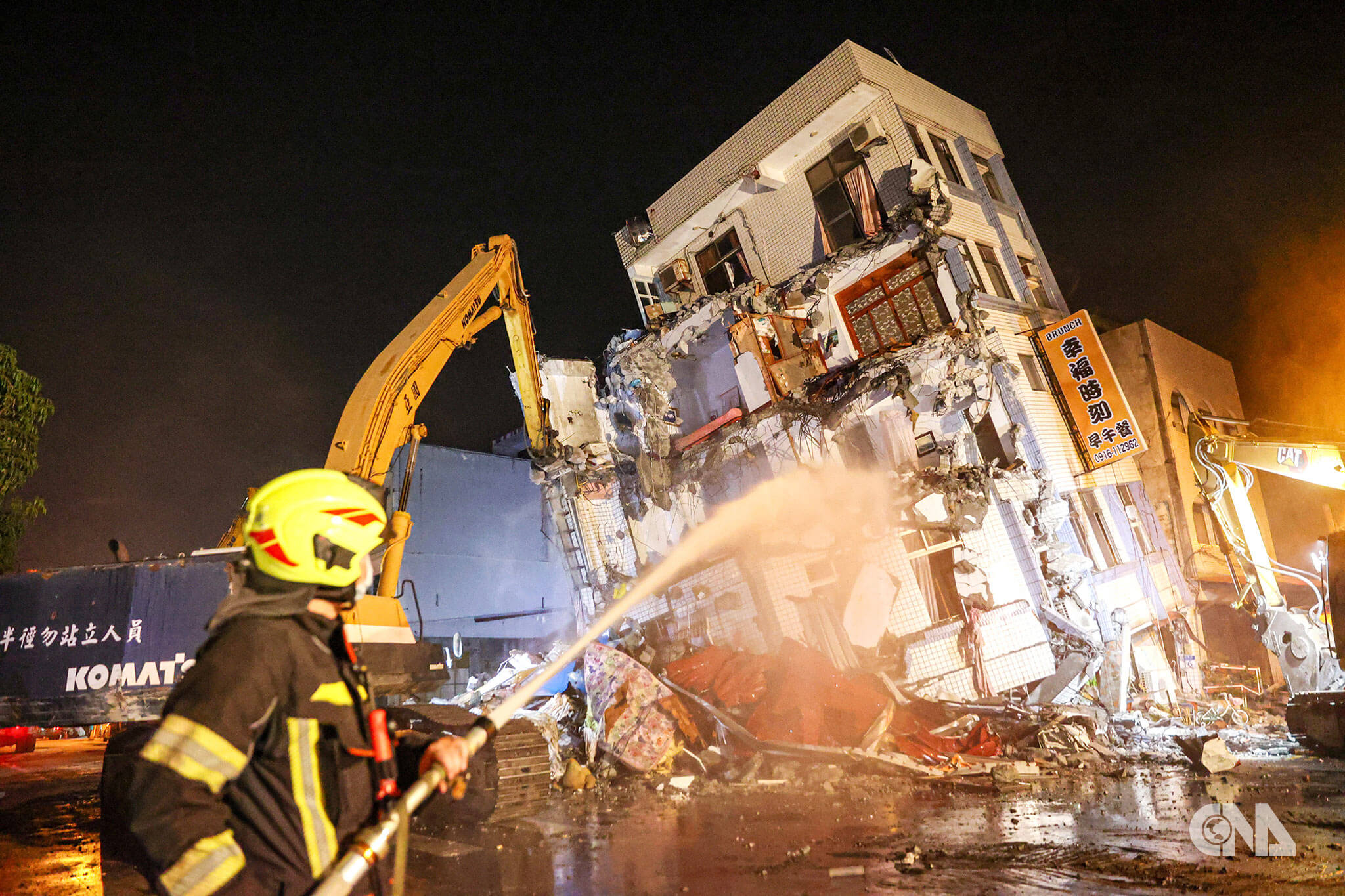 花蓮市北濱街與康樂街民宅因403地震嚴重傾斜，幸未造成傷亡，經過評估必須拆除，消防人員在現場灑水減少粉塵。